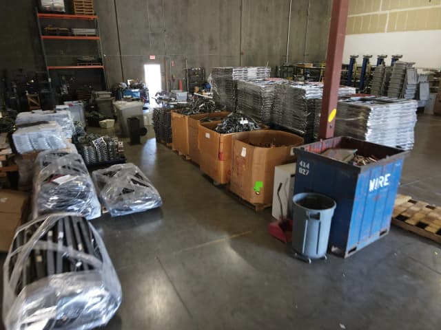 A spacious warehouse filled with numerous boxes stacked on pallets, showcasing an organized storage area.