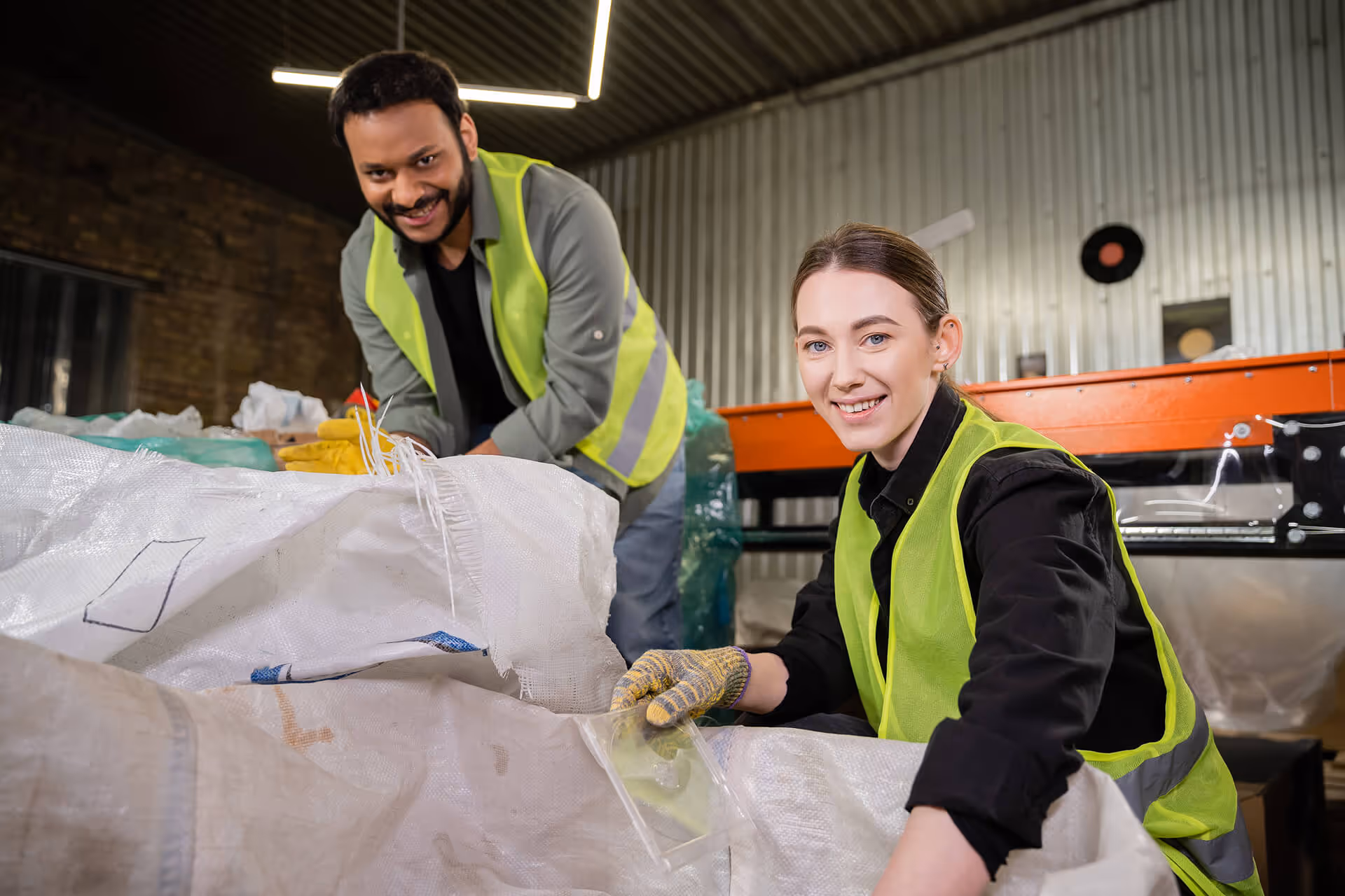 smiling young worker in reflective vest